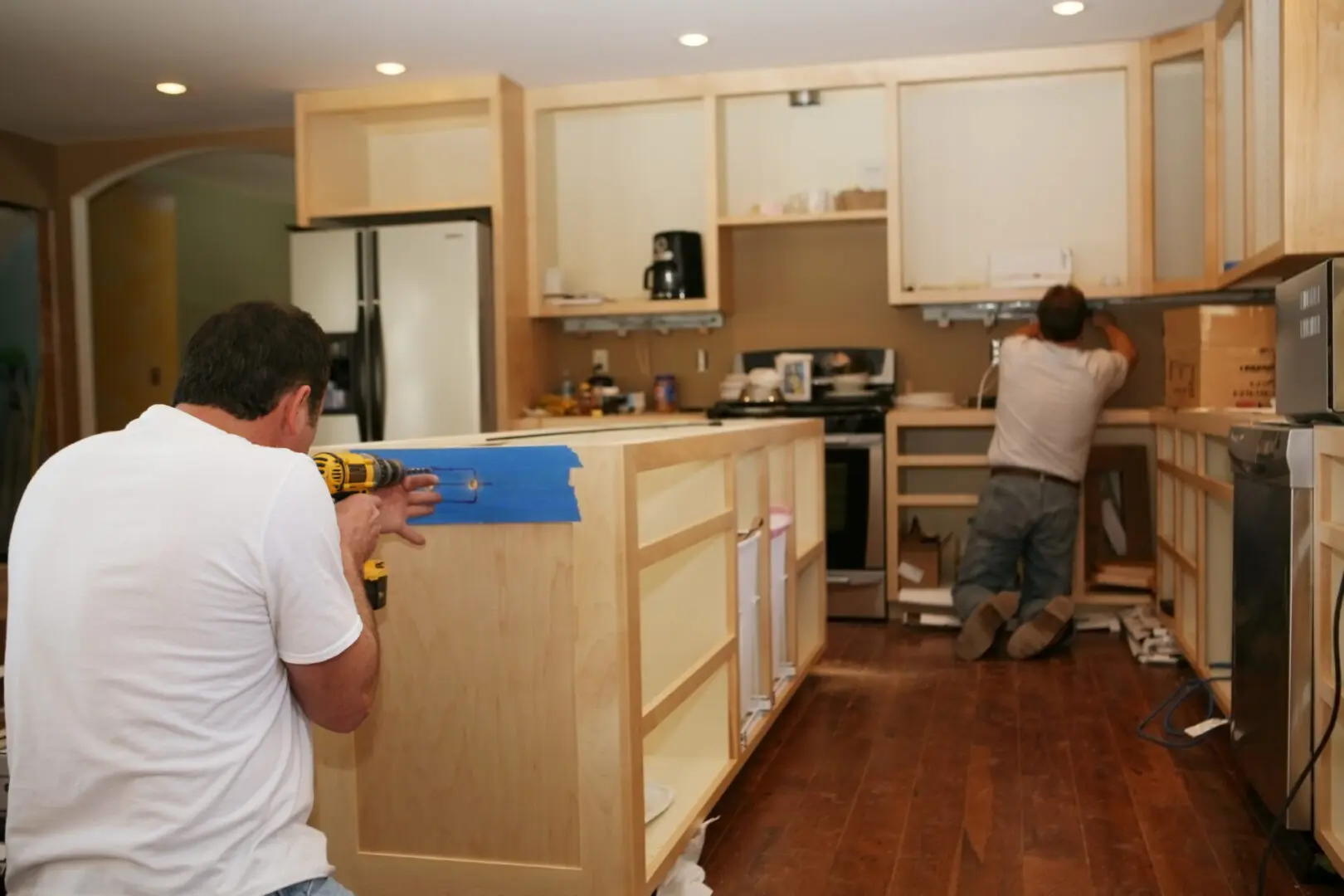 Installing cabinets in modern kitchen